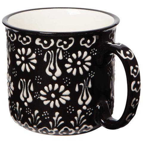 Black mug with white floral pattern on a white background