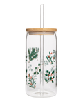 Clear glass tumbler with wooden lid and festive leaf pattern on a white background
