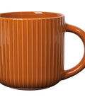 Brown ceramic mug with ribbed texture on a white background