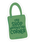Green bag-shaped sticker with 'The Shop Around the Corner' text on a white background