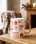 White mug with festive patterns on a wooden surface near a fireplace.