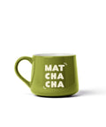 A bright green ceramic mug with the words 'MAT CHA CHA' printed in white on the front, set against a plain white background.