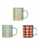 Three mugs with different patterns on a white background