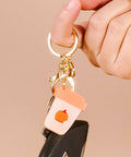Keychain with a pumpkin design on a beige background