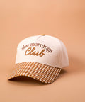 Cap with 'slow mornings Club' text on a beige background