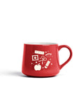 A red ceramic coffee mug with a white graphic print of school and office supplies, including a ruler, pencil, scissors, and apple, on a clean white background.