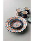 Colorful ceramic tableware set on a light gray background
