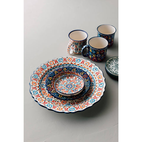 Colorful ceramic tableware set on a light gray background