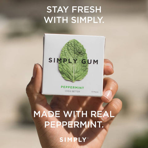Hand holding a box of Simply Gum with text 'Stay fresh with Simply' and 'Made with real peppermint'.