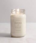 Pumpkin bread scented candle in a glass jar on a white background