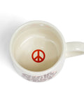 White mug with a red peace symbol on a white background