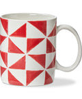 Mug with red and white geometric pattern on a white background